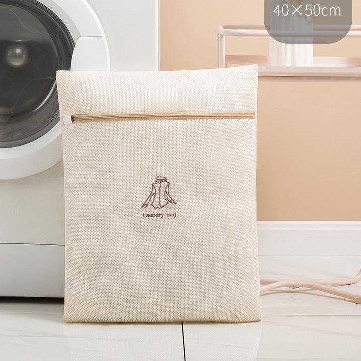 Beige laundry bag with icon on a washing machine in a laundry room.