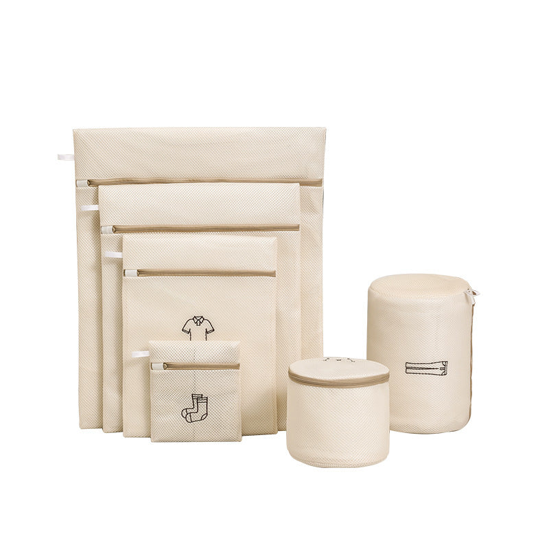 Set of beige fabric storage bags with labels on a white background