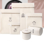Set of beige laundry bags with icons and a cylindrical basket on a light pink background