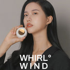 Woman holding a mini bladeless clip fan with 'WHIRL WIND' branding on a plain background