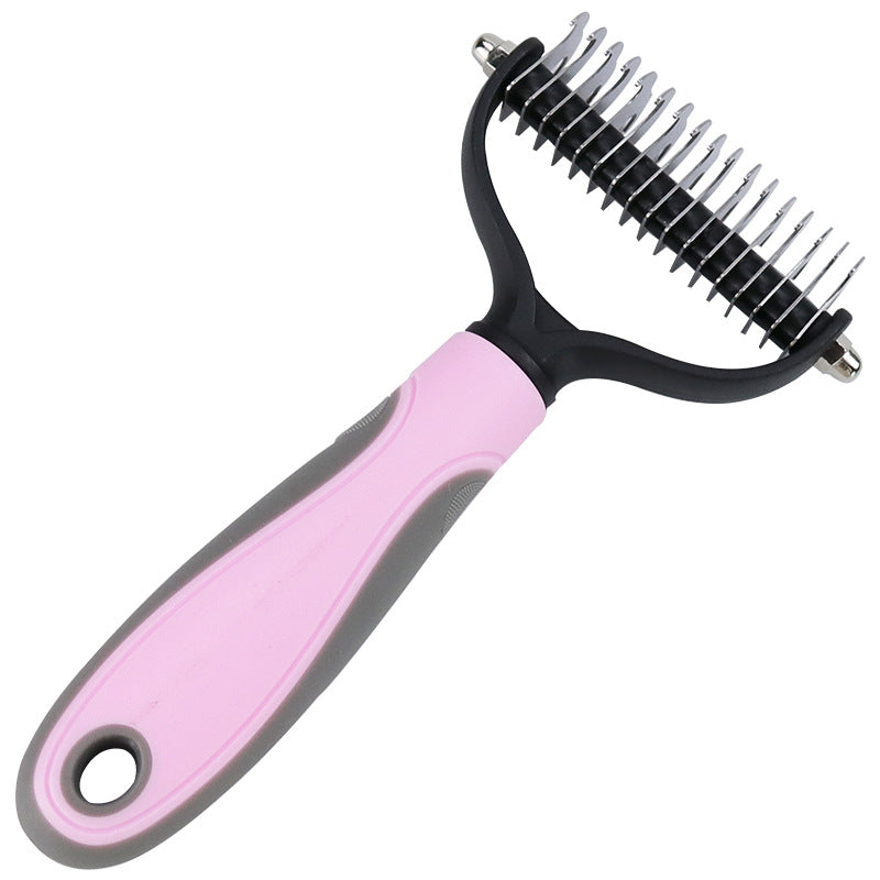 Pet grooming brush with pink handle and black bristles on a white background