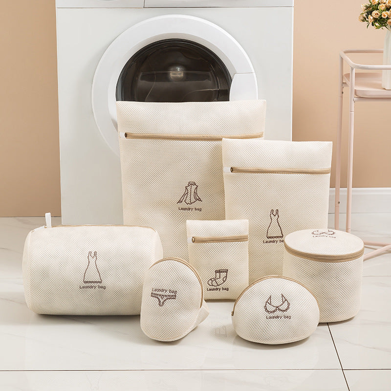 Set of beige laundry bags with icons in front of a washing machine.